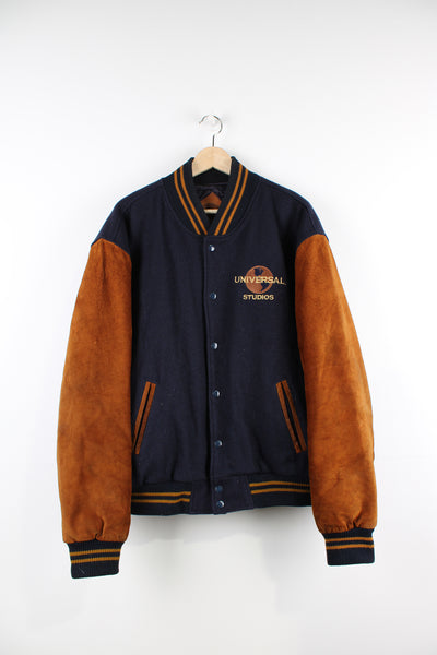 Vintage 00's Universal Studios blue and brown varsity jacket. Has a quilted lining and embroidered logo both on the front and back of the jacket. 