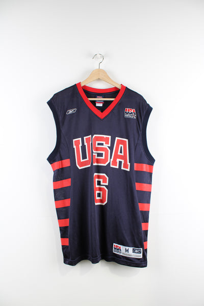 Team USA 2004 Athens Olympics basketball jersey by Reebok with #6 Tracy McGrady  printed lettering on the front and back  good condition  Size in Label:   M  Our Measurements:  Chest: 23 inches Length: 32 inches