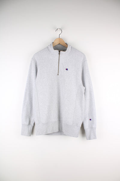 Champion Reverse Weave Quarter Zip Sweatshirt in a grey colourway, and has the logo embroidered on the front and left sleeve.