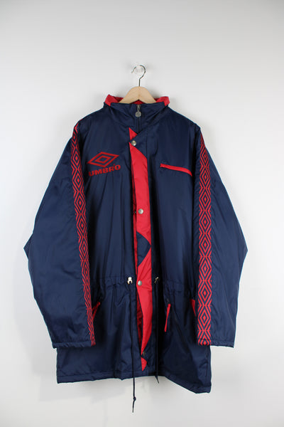 Vintage blue Umbro coat with logo on the chest and back and logo trim down the arms. Features a fold away hood.  good condition - small marks on the collar (see photos)  Size in Label:  XL