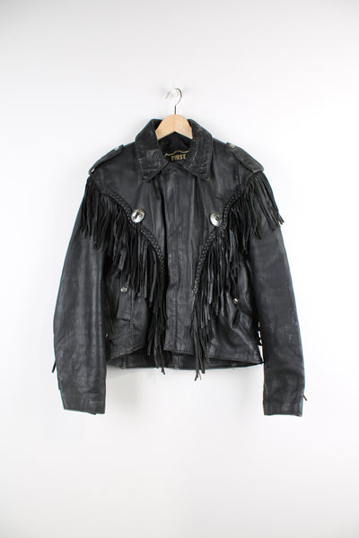 Vintage Western leather jacket in black, crafted from high quality black leather, zip up, fringed tassels on the front and back of the jacket, as well as conch buttons.