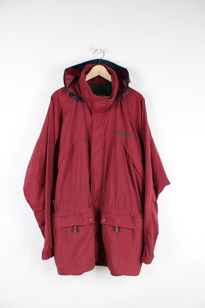 Timberland maroon red zip through, lightweight windbreaker jacket with fold away hood and embroidered logo on the chest