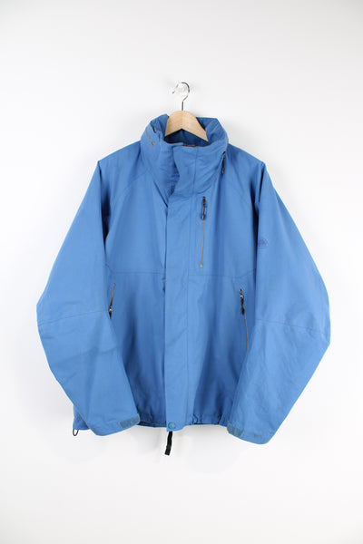 Nike ACG baby blue lightweight outdoor jacket featuring a full zip and hood