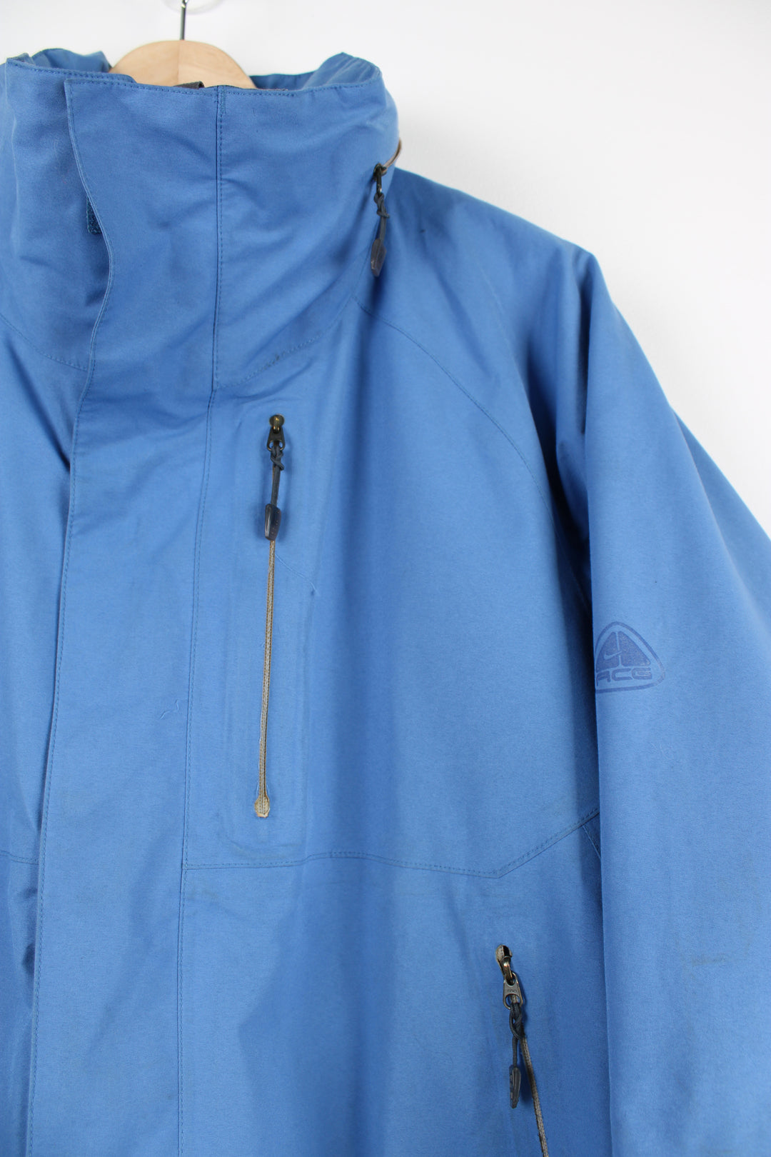 Nike ACG baby blue lightweight outdoor jacket featuring a full zip and hood