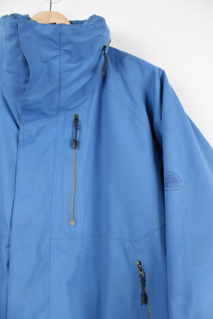 Nike ACG baby blue lightweight outdoor jacket featuring a full zip and hood