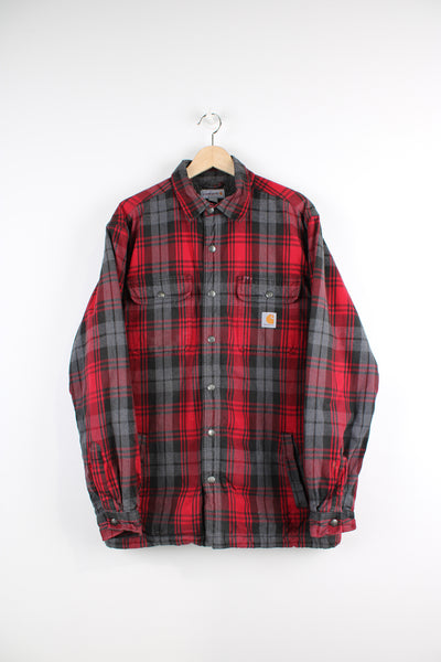 Red and grey Carhartt flannel shirt with fleece lining. Features popper buttons to close and Viking compass patch on the back.  good condition - small white paint mark by the pocket (see photos). Patch at the back has been added to cover a hole in the exterior fabric.  Size in Label:  Mens L