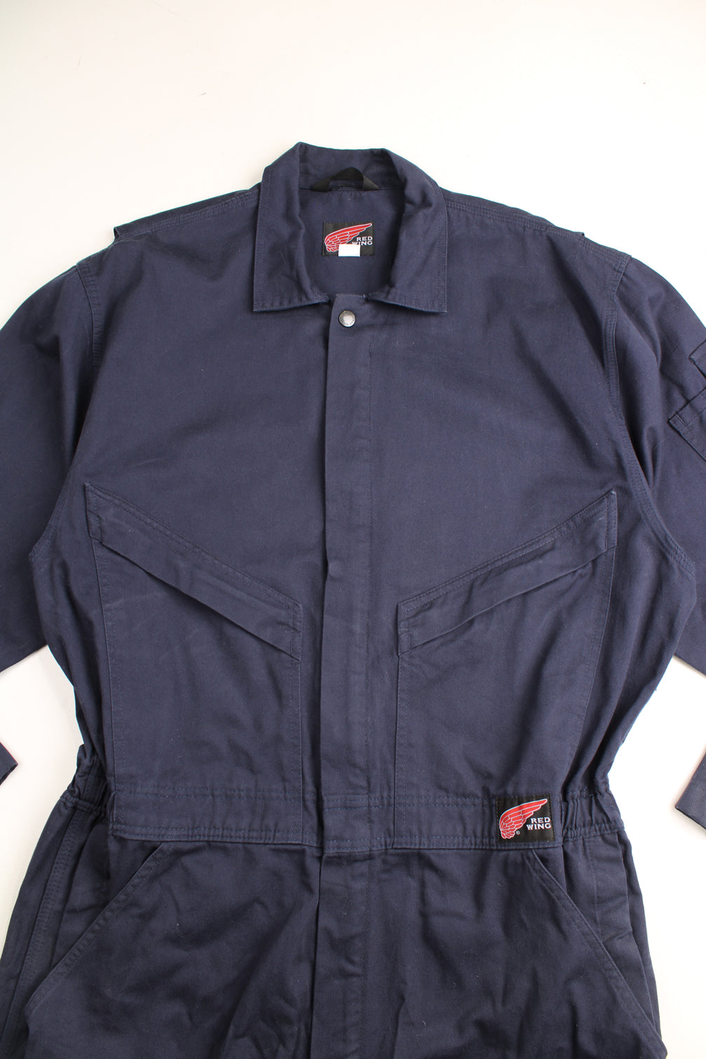 Red Wing full length cotton jumpsuit in navy blue with embroidered logo on the waistband. Waistband is elasticated at the back and closes . good condition- some marks on the legs (see images) Size in Label: UK Mens 42 (L)