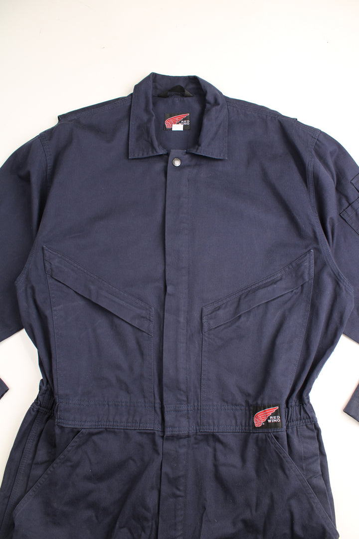 Red Wing full length cotton jumpsuit in navy blue with embroidered logo on the waistband. Waistband is elasticated at the back and closes . good condition- some marks on the legs (see images) Size in Label: UK Mens 42 (L)