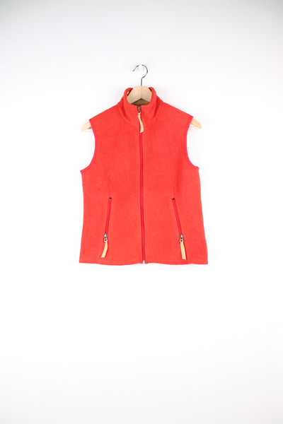 Patagonia Synchilla Fleece Gilet in a orange colourway, zip up with side pockets.