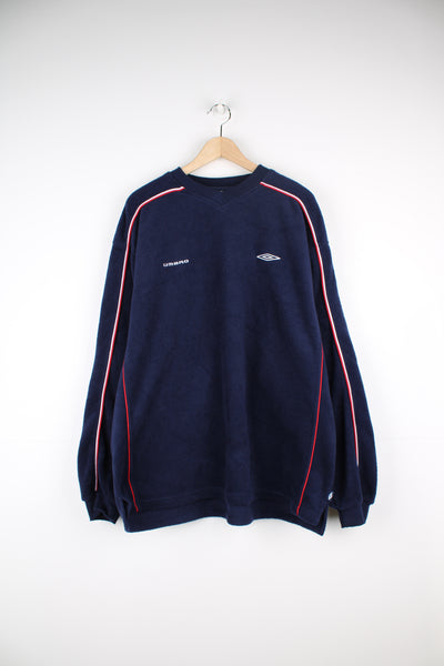 Umbro Sweatshirt Fleece in a blue colourway with red and white stripes going down the sides, v neck, and has the logos embroidered on the front.