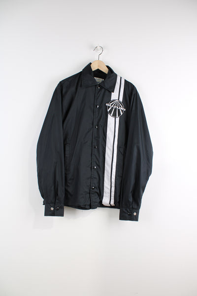 Vintage all black, button up nylon coach jacket by Suzuki. Features embroidered badge on the chest  