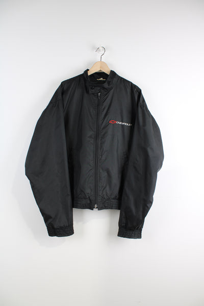 Vintage all black, zip through nylon bomber jacket by Chevrolet. Features embroidered badge on the chest&nbsp;