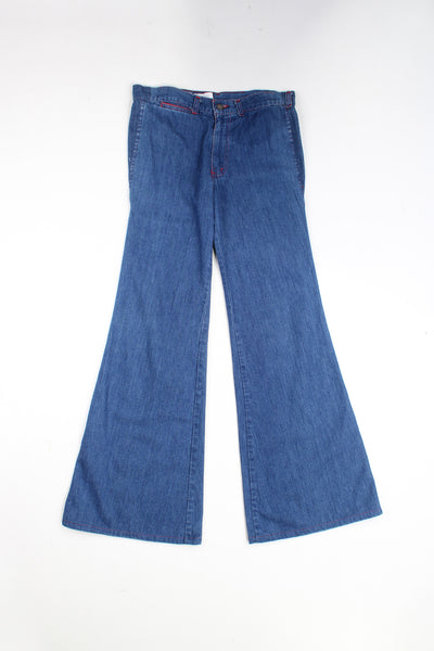 Vintage 70's blue denim flared/ bell bottom jeans with red contrast stitching.   good condition  Size in Label:  27 X Long