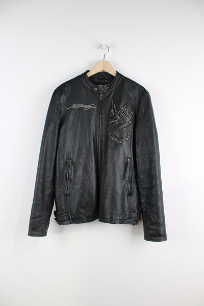 Vintage Ed Hardy Leather Jacket in a black and grey colourway, zip up, side pockets, adjustable waist belts, and has logo embroidered on the front as well as a big back piece.