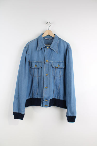 Vintage Lee Denim Jacket in a blue colourway, button up, double chest pockets, and has logo embroidered on the chest.