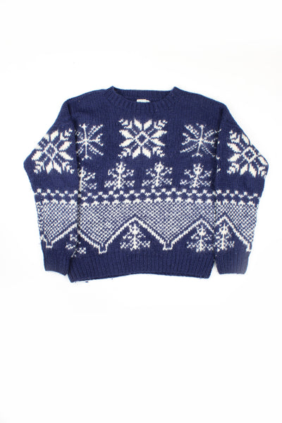 Vintage blue hand knit 100% wool jumper. Navy blue with white snowflake motif throughout.   good condition - some slight discoloration on the neck but nothing of note.  Size in Label:  S - Measures more like a M for a more fitted look.