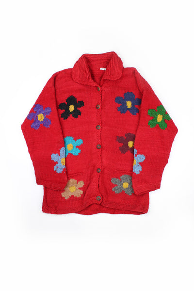 Vintage red chunky knit cardigan with floral design. Made in Ecuador from 100% wool. Has two front pockets and closes with buttons