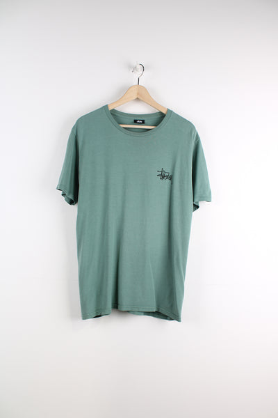 Stussy T-Shirt in a green and black colourway, has the logo printed on the front and back.