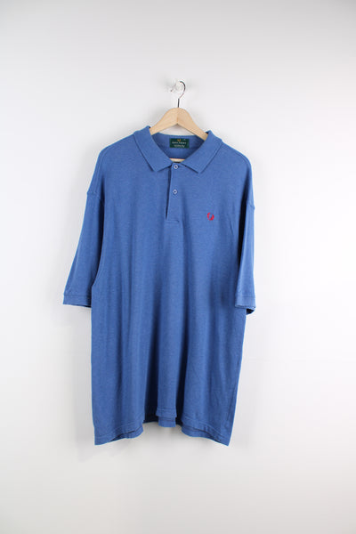 Fred Perry Polo Shirt in a blue and red colourway, quarter button up, and has the logo embroidered on the chest.
