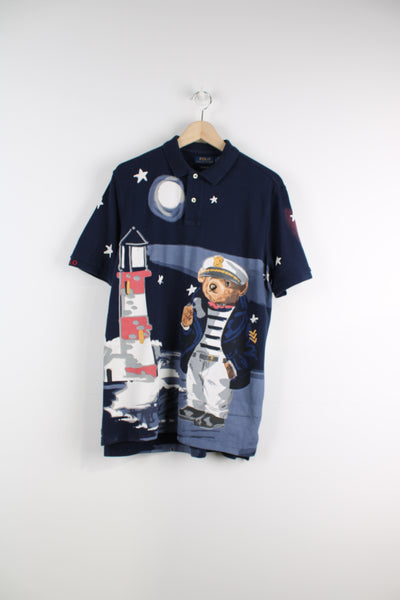 Ralph Lauren Nautical Bear Polo Shirt in a blue colourway with all over sailor bear print graphic on the front and back, 1/4 button up.