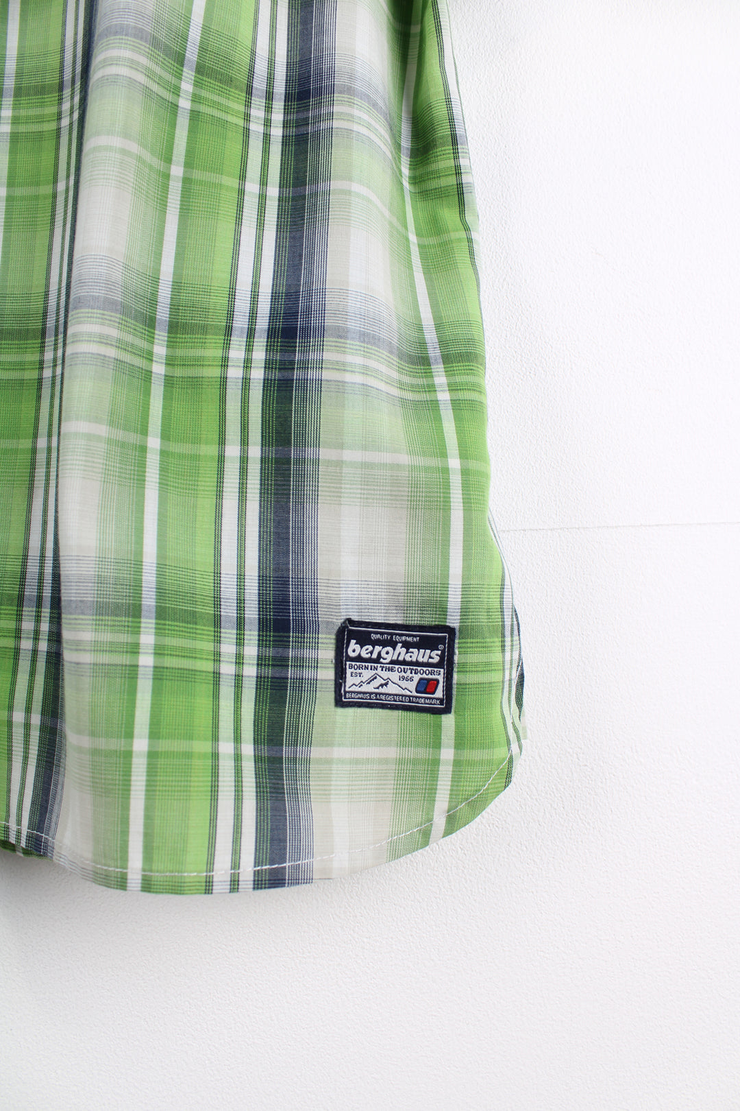 Berghaus Short Sleeved Plaid Shirt in a green, white and blue colourway, button up with a chest pocket, and logo embroidered on the bottom.