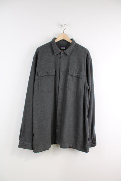 Patagonia Shirt in a grey colourway, button up, double chest pockets, and logo embroidered on the side.