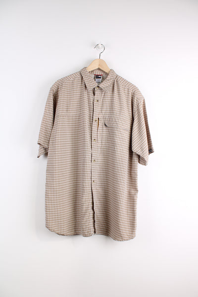 The North Face Short Sleeve Plaid Shirt in a tan and orange colourway, button up with chest pockets, and logo embroidered on the side.