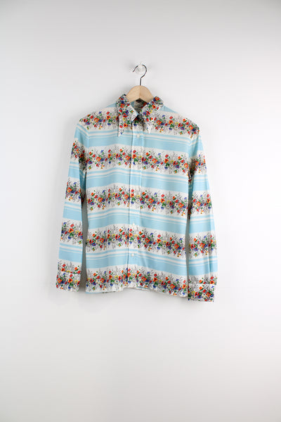 Vintage 70's Loubella Patterned Blouse in a white and blue striped colourway with multicoloured flowers printed across, button up, and has a dagger collar.