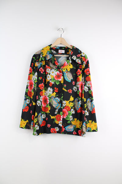Vintage 70's Patterned Blouse in a black colourway with multicoloured flowers printed all over, button up, and has a camp collar.