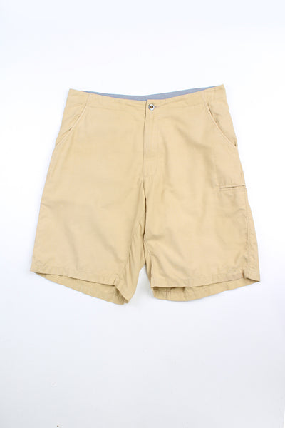 Beige Patagonia shorts. Features embroidered logo on the back. 