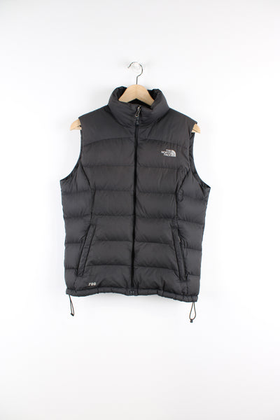Women's The North Face 700 black puffer gilet with kangaroo pockets, draw string hem and embroidered logo on the front and back