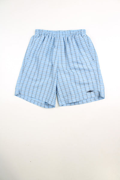 Blue Umbro checked shorts with elasticated waist and drawstring. Features embroidered logo on the leg.