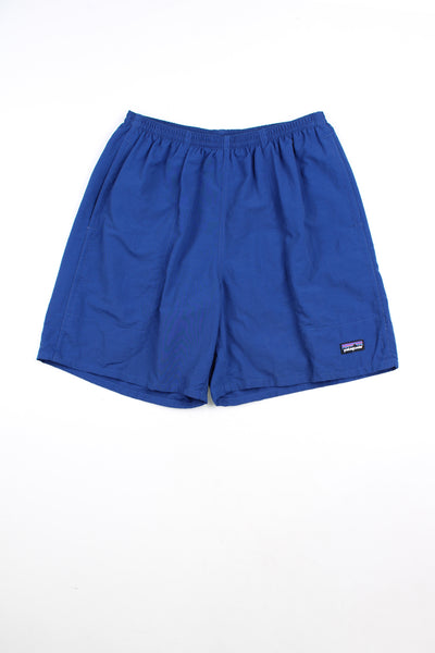 Blue Patagonia swim shorts with elasticated waistband and drawstring tie. Features embroidered patch logo on the leg.