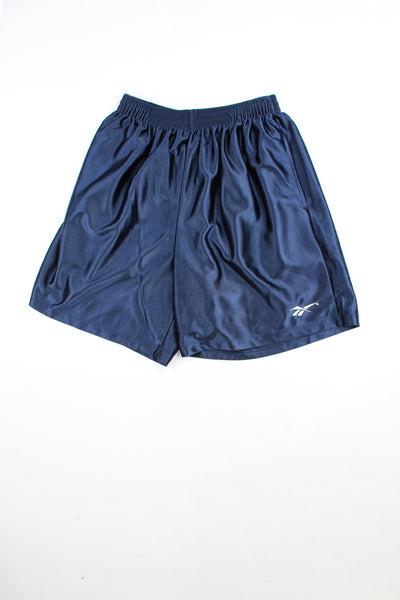 Navy blue Reebok shorts with elasticated waist and drawstring. Features embroidered logo on the leg.