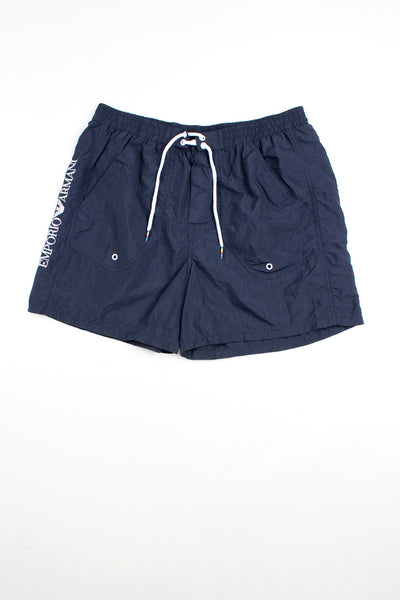 Navy blue Emporio Armani swim shorts with elasticated waistband and lace up tie at the front. Features embroidered logo on the leg.