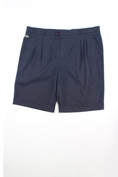 Navy blue vintage 80's Chemise Lacoste chino style shorts. pleated at the front with embroidered logo just below the waistband.&nbsp;
