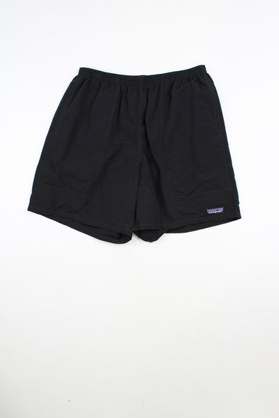 Black Patagonia shorts with elasticated waistband with drawstring tie. Features embroidered patch logo on the leg.
