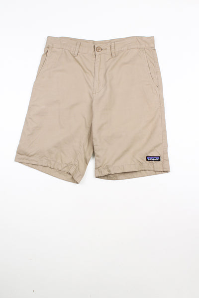 Tan khaki Patagonia shorts. Features embroidered patch logo on the leg.