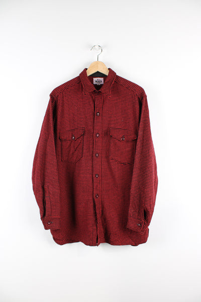 Vintage Woolrich red and black plaid button up shirt with two chest pockets.
