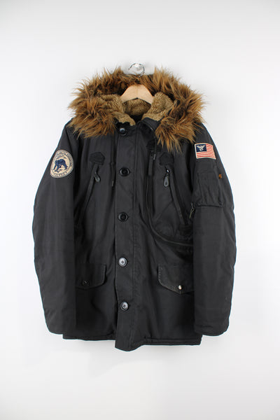 Vintage Alpha Industries hooded parka jacket in black, features multiple pockets, faux fur lined hood and embroidered patches on both arms.