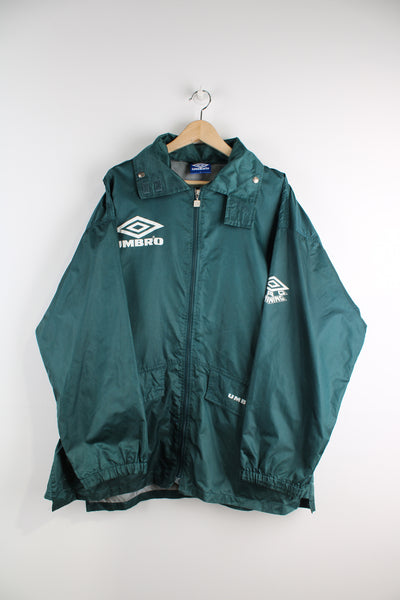 Umbro Pro Sport forest green lightweight  jacket features printed logos on the chest and back, foldaway hood and pockets 