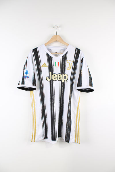Juventus 2020/21 Adidas home football shirt, white, black and gold colourway, has the number 7 printed on the back and logos embroidered on the front. 