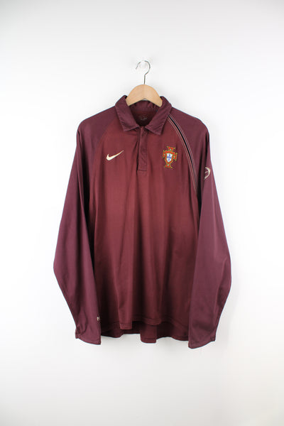 Vintage Portugal, Nike Long Sleeved Polo Shirt in a burgundy colourway, button up and has logos embroidered on the front and sleeves.