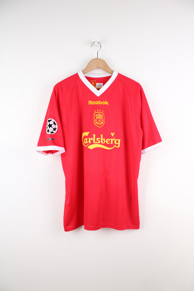 Vintage Liverpool 2001/03 Champions League, Reebok Football Shirt in a red, white and yellow colourway, John Arne Riise number 18 printed on the back, V-neck, and has logos embroidered on the front and sleeve.