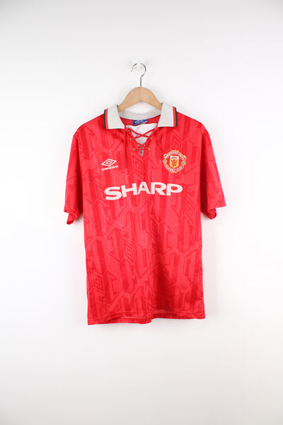 Vintage Manchester United 1992/94, Umbro Football Shirt in a red and white team colourway, Eric Cantona number 7 printed on the back, and has logos printed on the front.