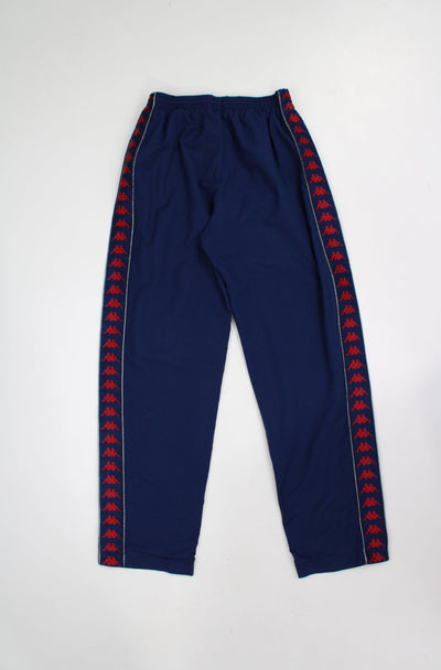 Vintage Kappa navy blue tracksuit bottoms with branded ribbon down both sides of legs 
