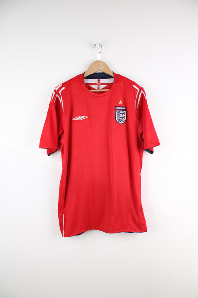 Vintage England 2004/06, Umbro Away Football kit in a red and white colourway, and has embroidered logos on the front.