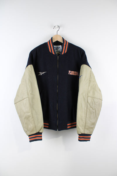 Vintage Reebok Florida Gators varsity jacket, zip up with side pockets, quilted lining, has embroidered logos on the front and back of the jacket. 