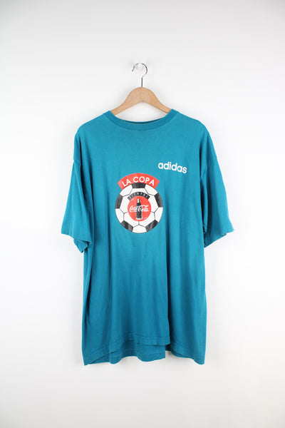 Vintage 90's Adidas, Coca Cola Single Stitch T-Shirt in a blue colourway, football graphic printed on the front alongside the Adidas logo, and number 18 printed on the back.