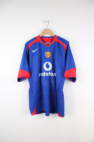 Manchester United 2005/06, Nike Football Kit in a blue, white and red colourway, signed by the players, V-neck and has logos printed on the front.